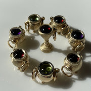 Gold cauldron charms surrounded by a gold goblet charm.