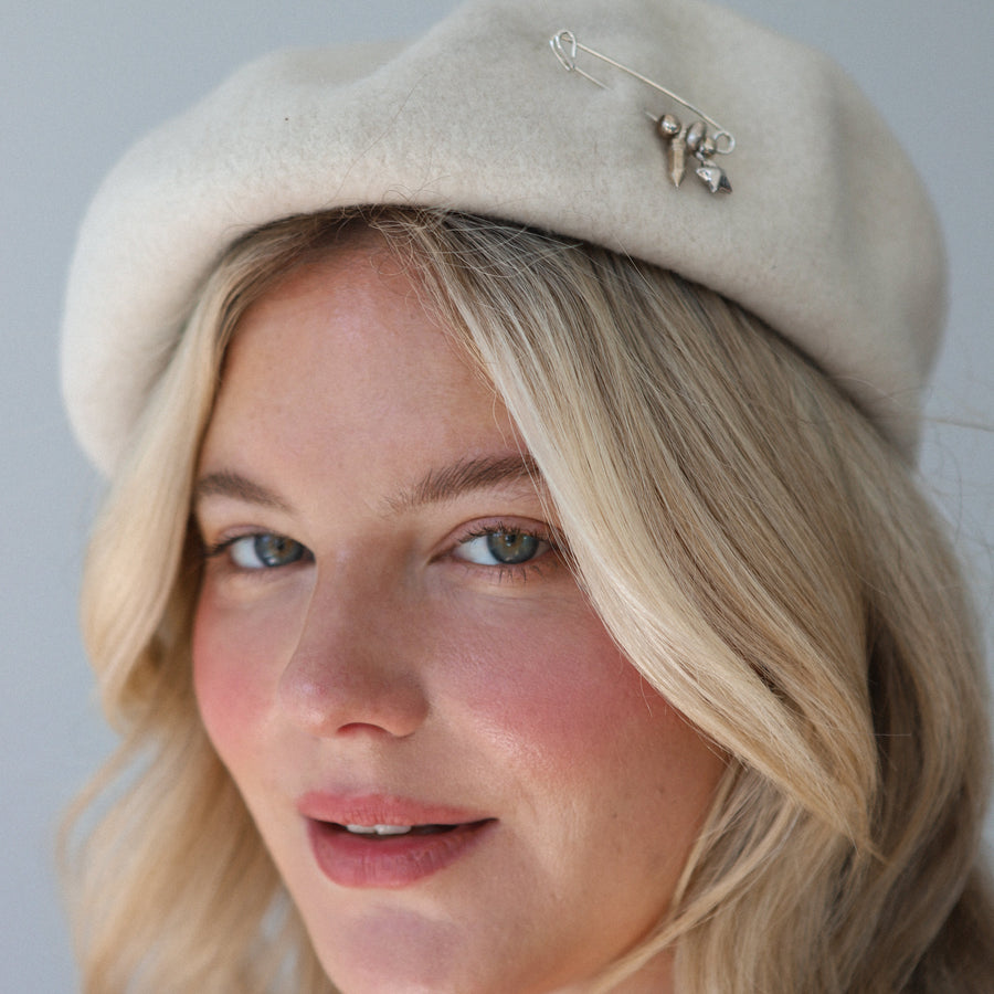 Silver Safety pin in a beret.