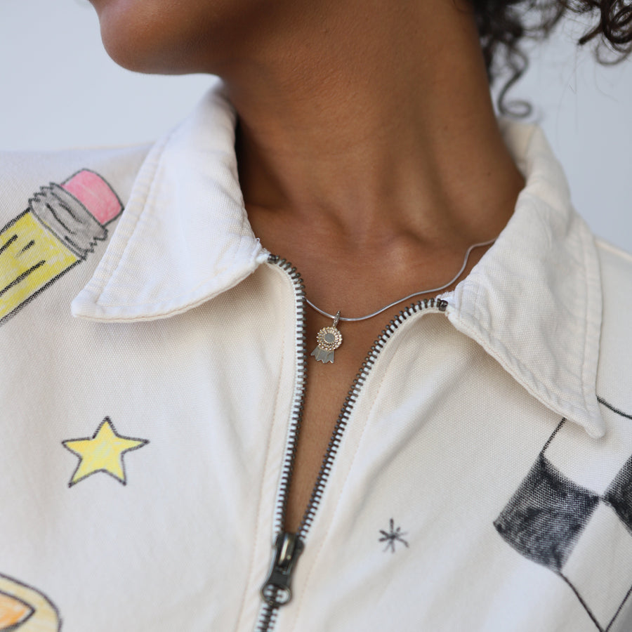 Close-up of a person wearing a white jacket with colorful graphics and text.