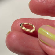 Close-up of a hand with yellow nail polish on a white background