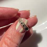 Hand holding a ring with a white background