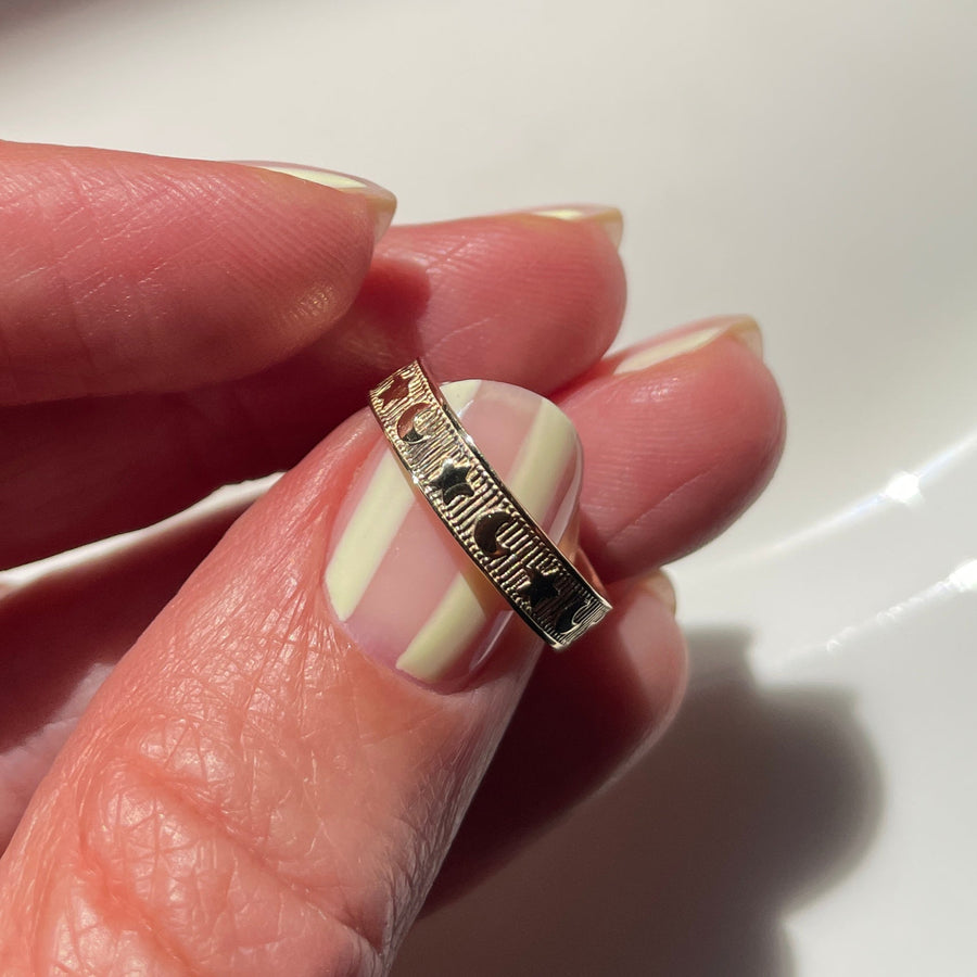 Hand holding a ring with a white background