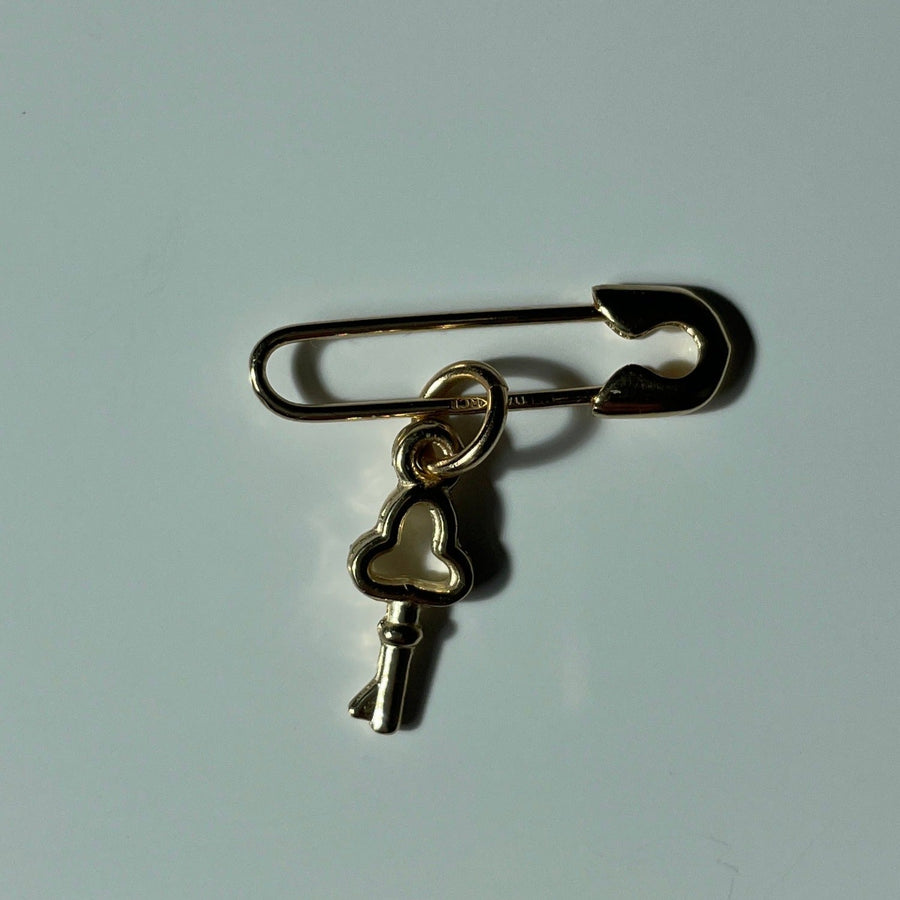 Key on gold safety pin