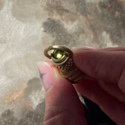 Keary & James original object. A solid gold perfume bottle with a peridot set on top.