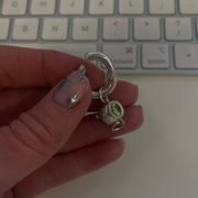 Sterling silver cauldron charm being held