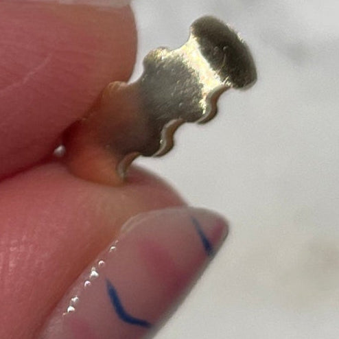 gold wavy bead in hand