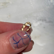 gold wavy bead in hand