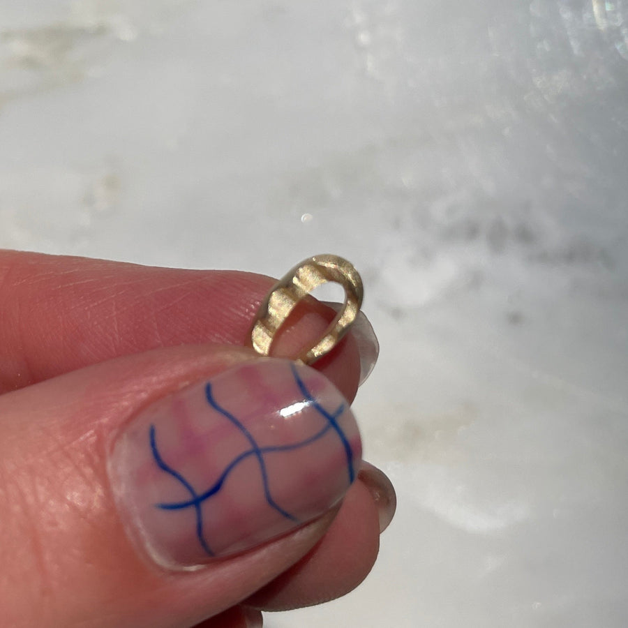gold wavy bead in hand