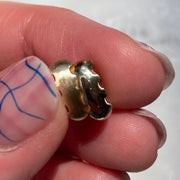 gold wavy bead in hand