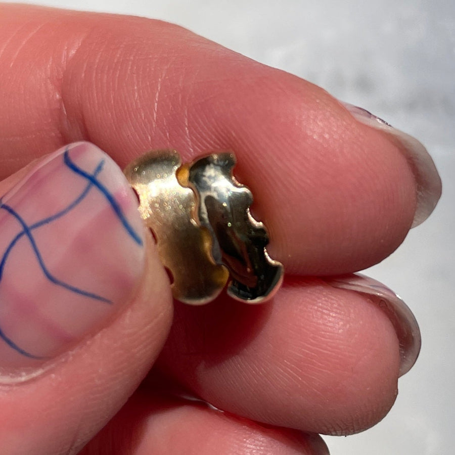 gold wavy bead in hand