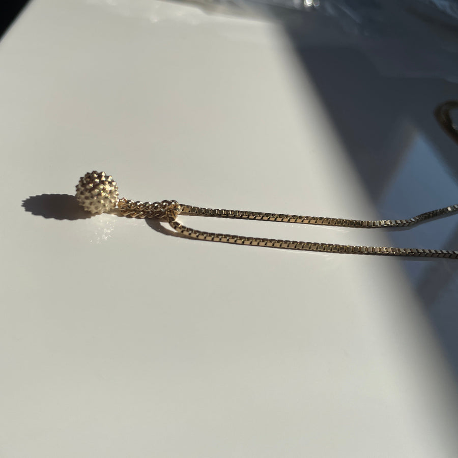 Necklace with a small pendant on a light gray background