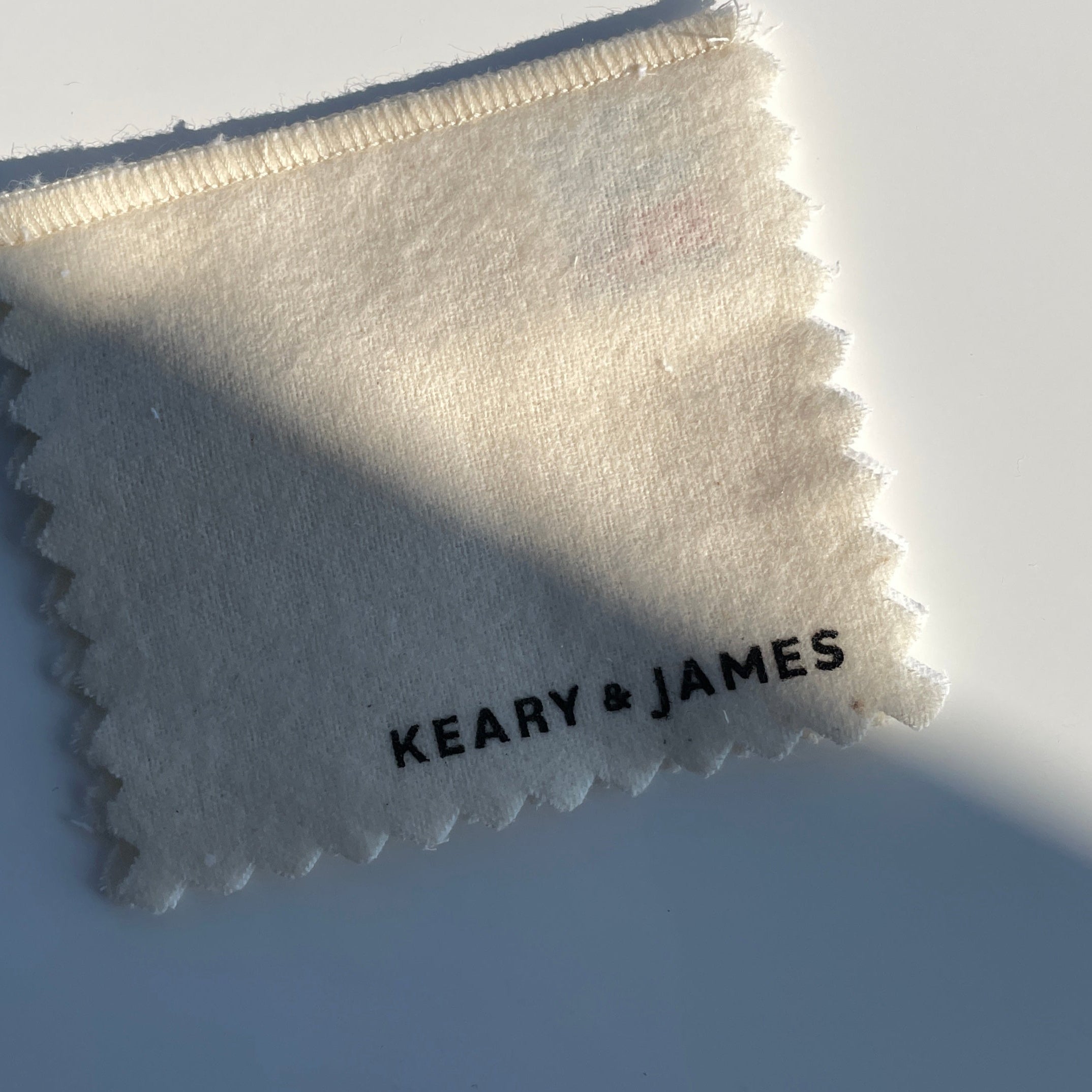 White cleaning cloth with 'Keary & James' branding on a light gray background