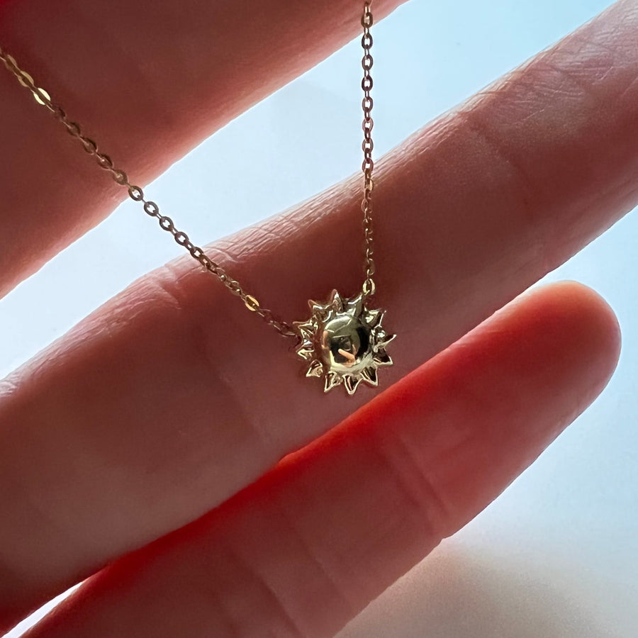 Holding Sun Necklace